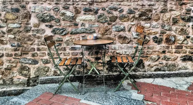 A peaceful outdoor bistro table with two chairs, setting a collaborative space for couples therapy in California.