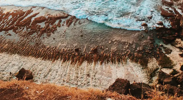 Waves breaking gently against a rocky coastline, illustrating emotional repair in couples conflict counseling.