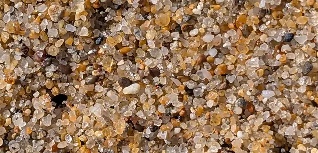 Smooth, grounded beach pebbles stacked together, depicting anxiety tolerance in ERP therapy for OCD.